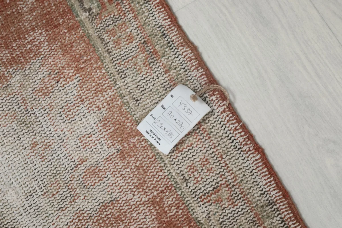 Close-up of the back of the rug showing a product tag with size and origin details