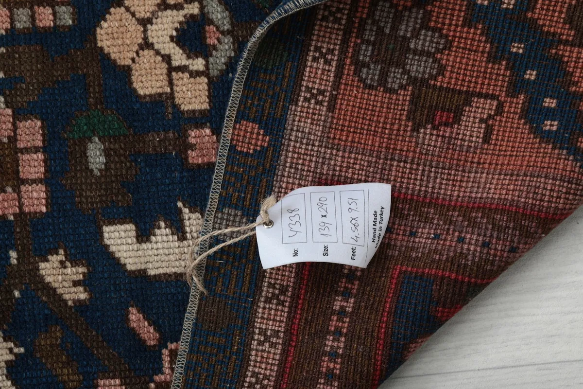 Close-up of the rug's back with a size tag showing dimensions in feet and centimeters