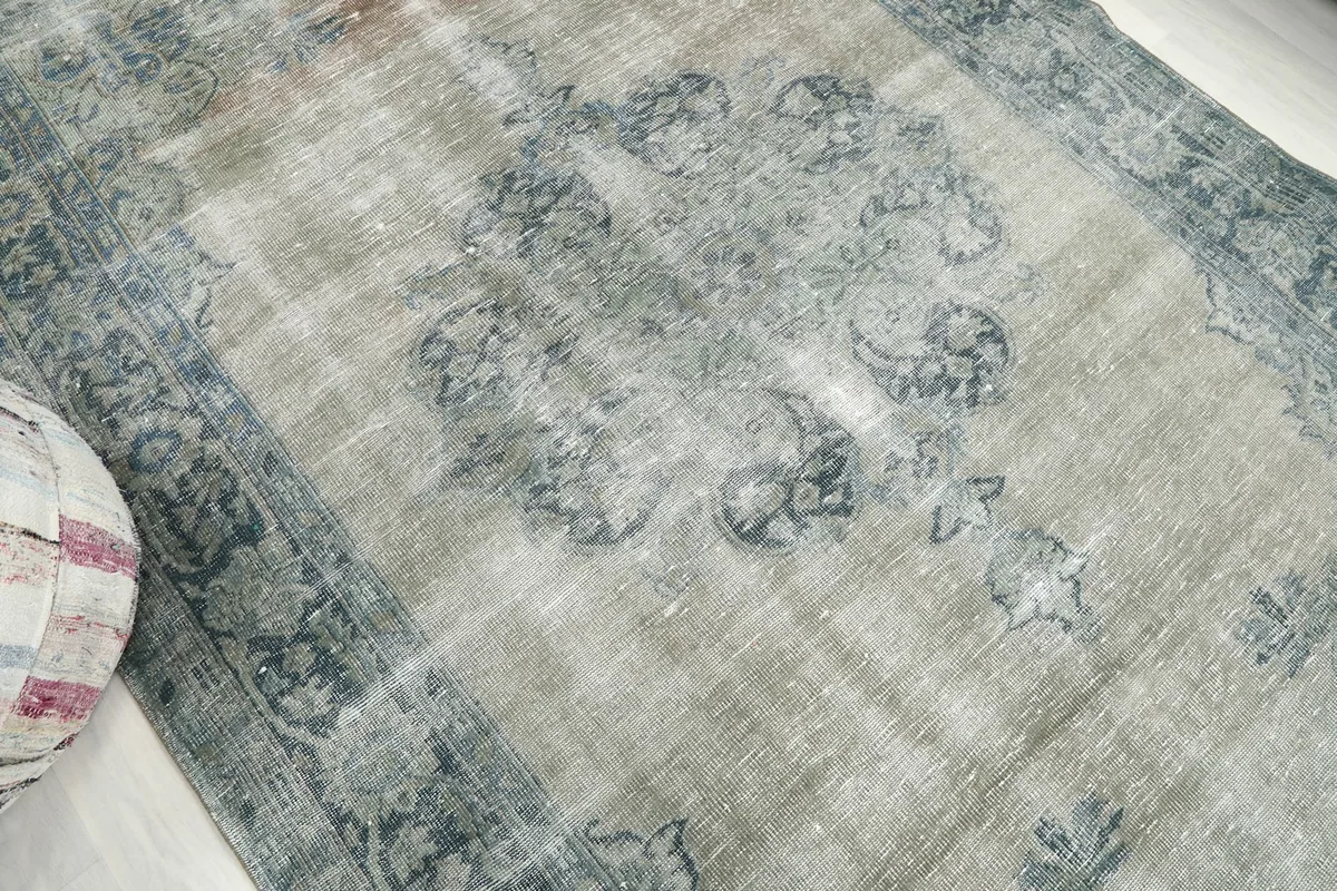 Close-up of the central medallion and surrounding geometric motifs on the rug