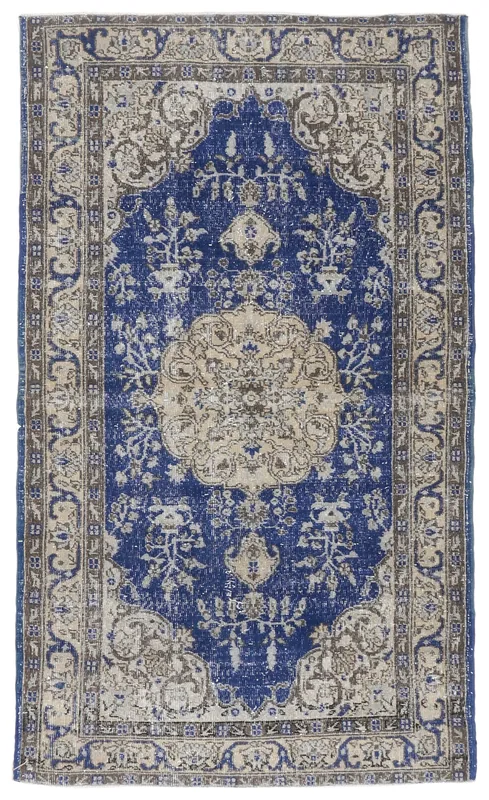 Full overhead view of the blue medallion vintage Anatolian rug on a white background