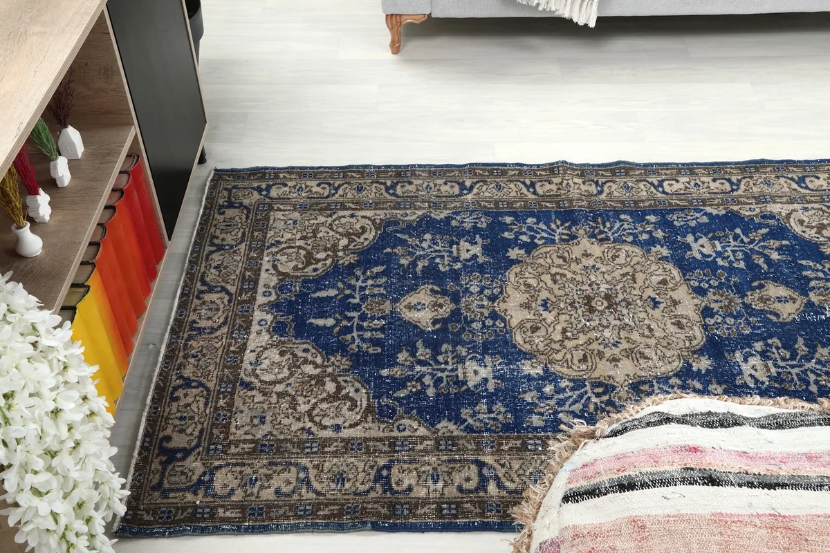 Wide angle view of the blue vintage rug laid out in a contemporary living space