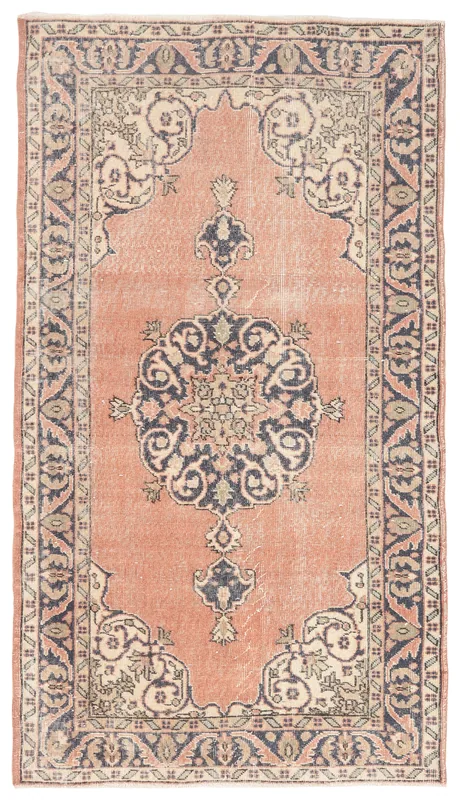 Full overhead view of the rust vintage Anatolian rug with a central medallion on a white background.