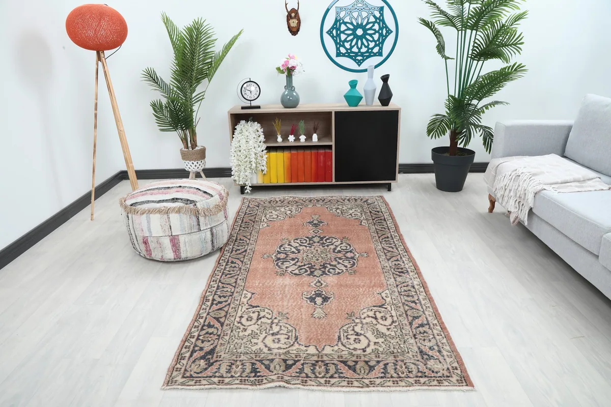 Vintage rust rug displayed in a living room setting with modern furniture and decor.