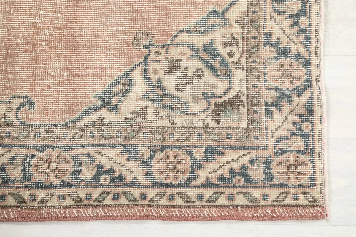 Close-up of the lower right corner and outer border, revealing the fine hand-knotted detail and colors.