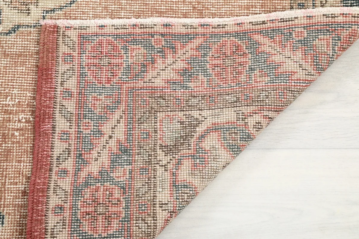 Detailed view of the rug's reverse side, showing the dense hand-knotting and the cotton foundation.