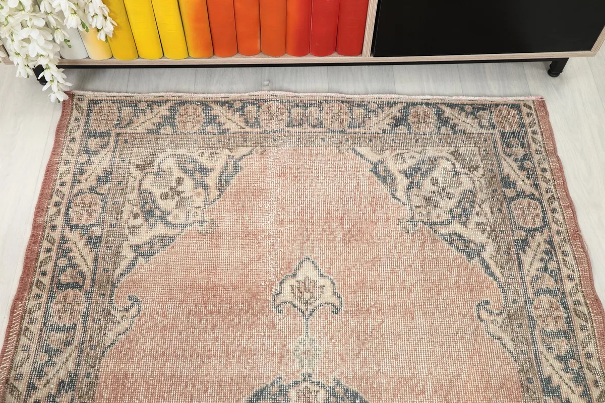 Top-down view of the top section of the rug, showing the corner motifs and part of the main field.