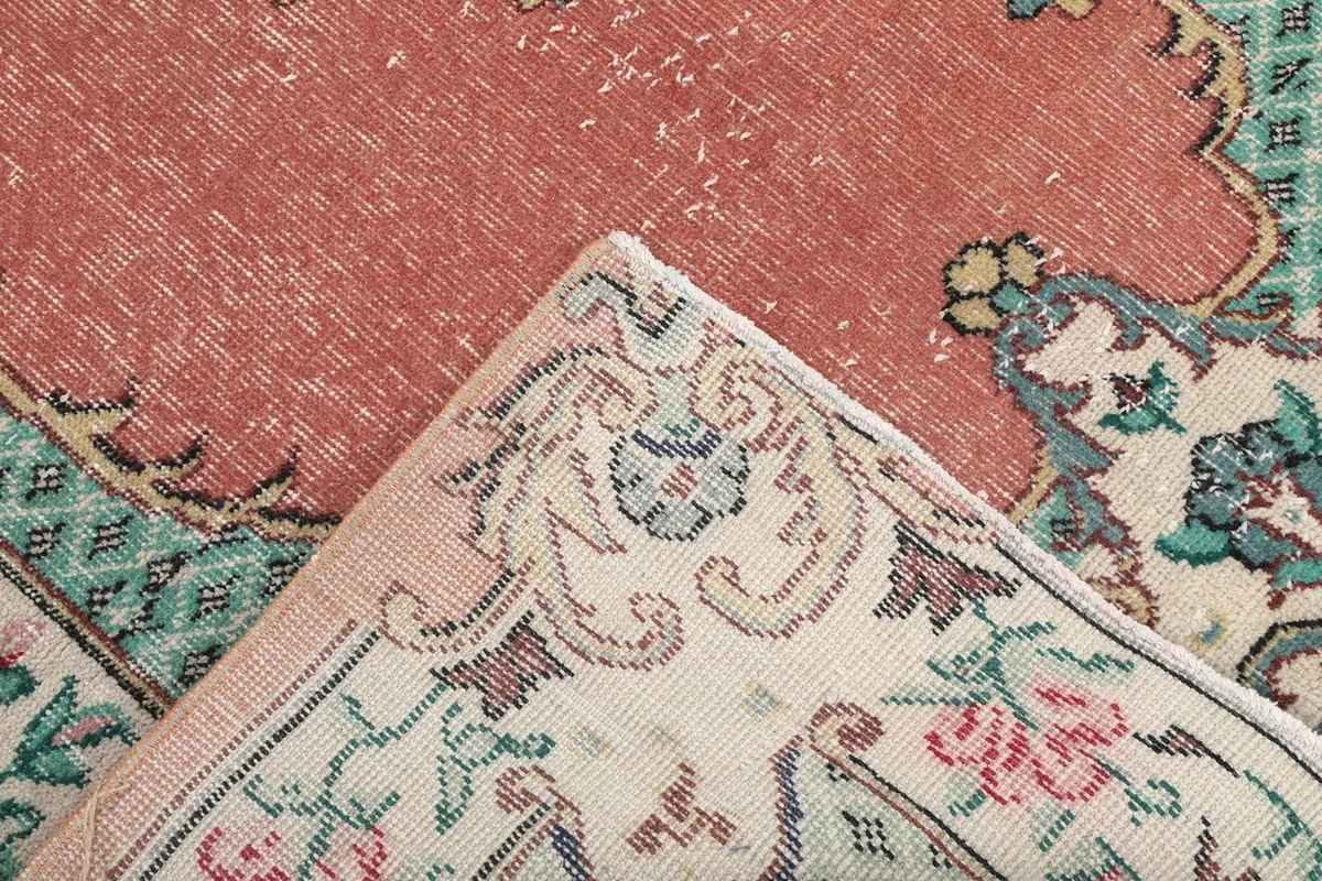 Close-up of the rug's low wool pile and the intricate hand-knotted details
