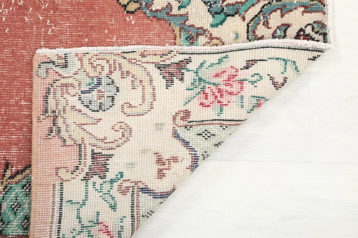 Underside view of the hand-knotted cotton foundation and wool pile of the vintage rug