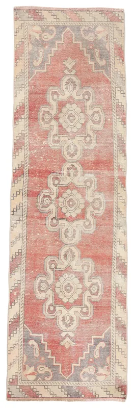 Full overhead view of the rust runner rug with ivory and gray geometric medallions