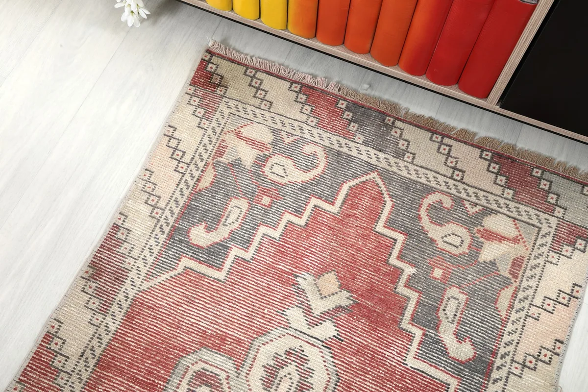 Overhead angled view of one end of the rug, showing border design and colors