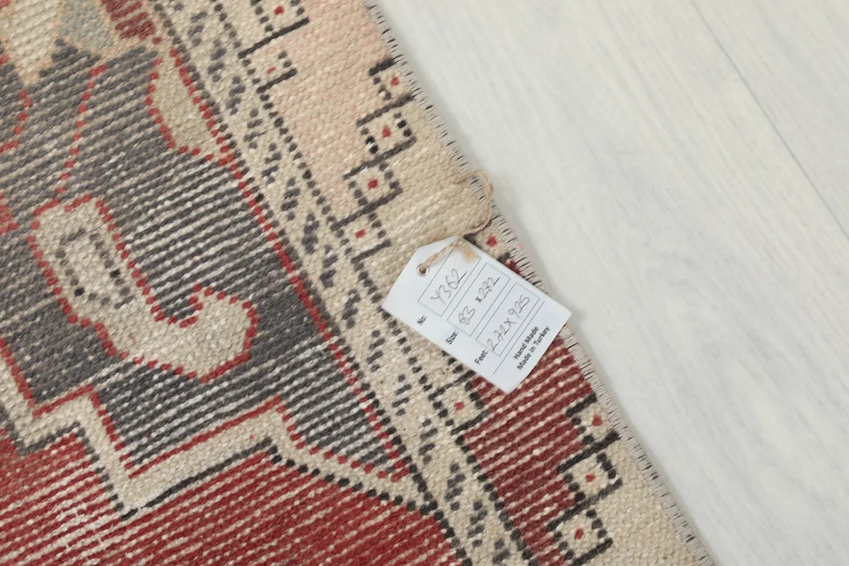 Corner of the rug with the product tag, showing details like size and material