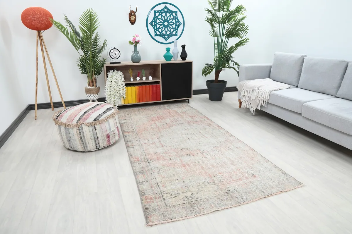 Angle view of the rose and beige rug in a modern living space, highlighting its placement.