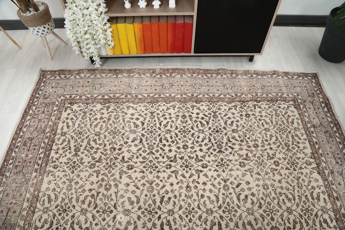 Wide shot of the ivory and brown floral rug in a room, emphasizing its presence as a central decor element.
