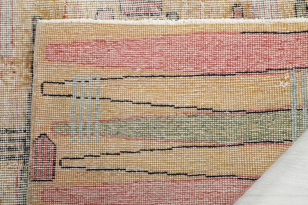 Close-up of the rug's back, showing the consistent knotting and cotton foundation structure