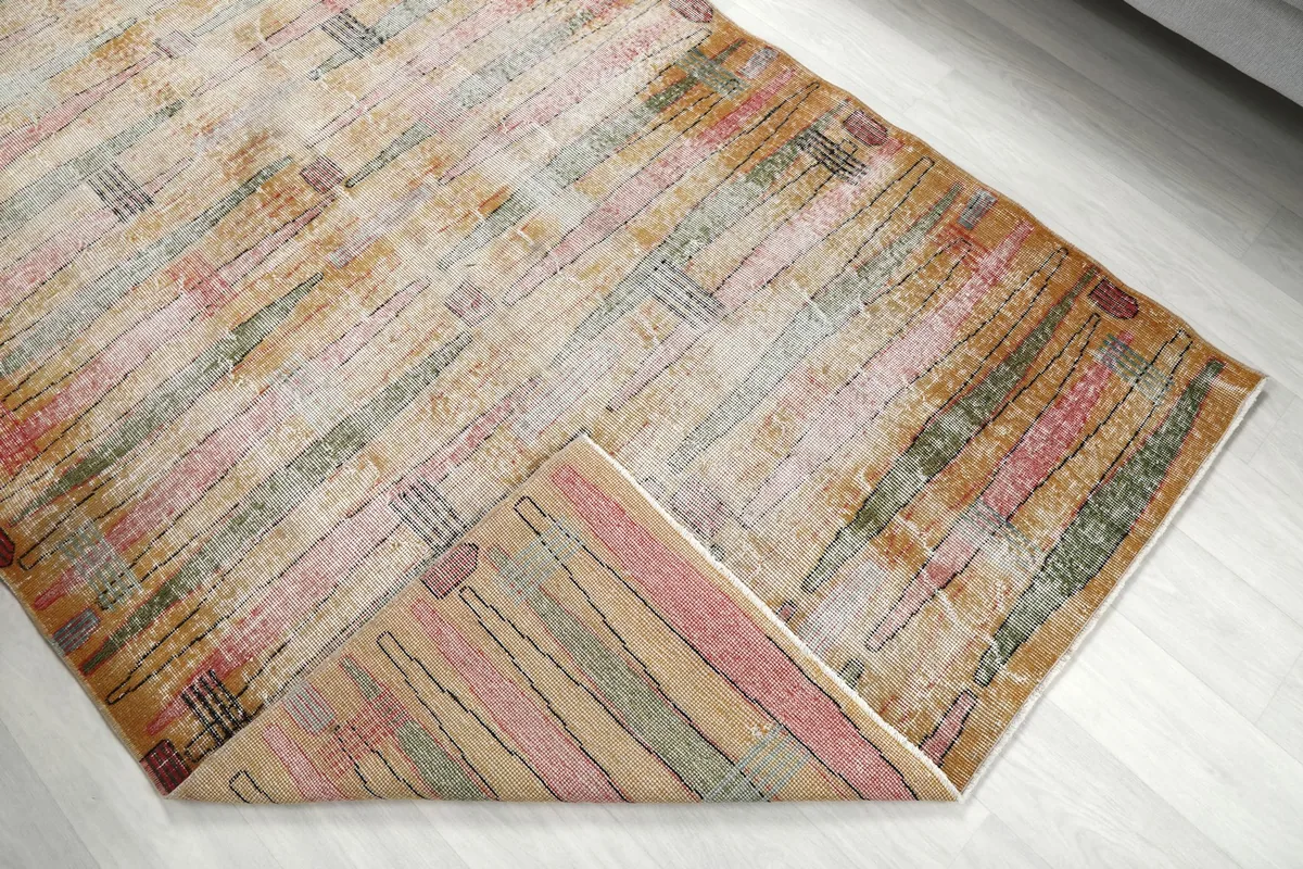 Corner of the rug folded back to reveal the cotton foundation and reverse side of the knots