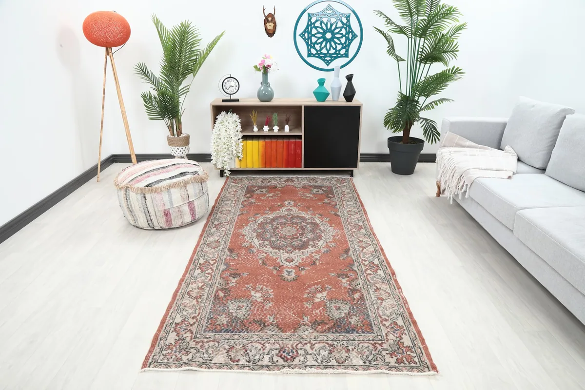 Rust runner placed in a modern living room setting with a couch and plants