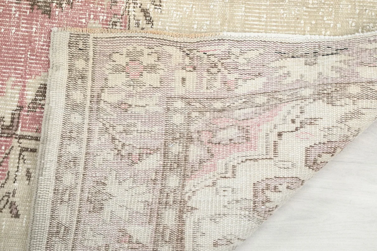 Underside of the rug, showing the cotton foundation and hand-knotted construction.