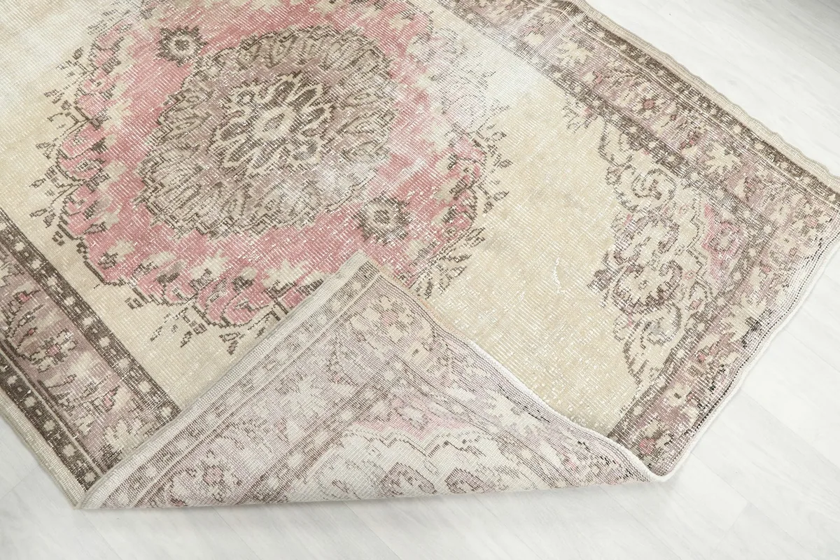 Folded corner of the rug, revealing the thickness of the hand-knotted wool pile.