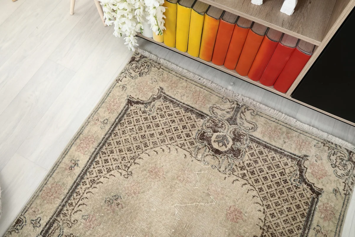 Overhead angle of the rug in a room, focusing on the top half of the design