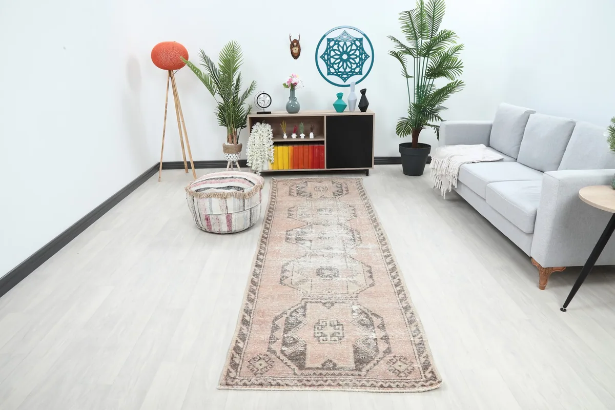 Vintage runner rug in a modern living space with light flooring, showing its length and scale.