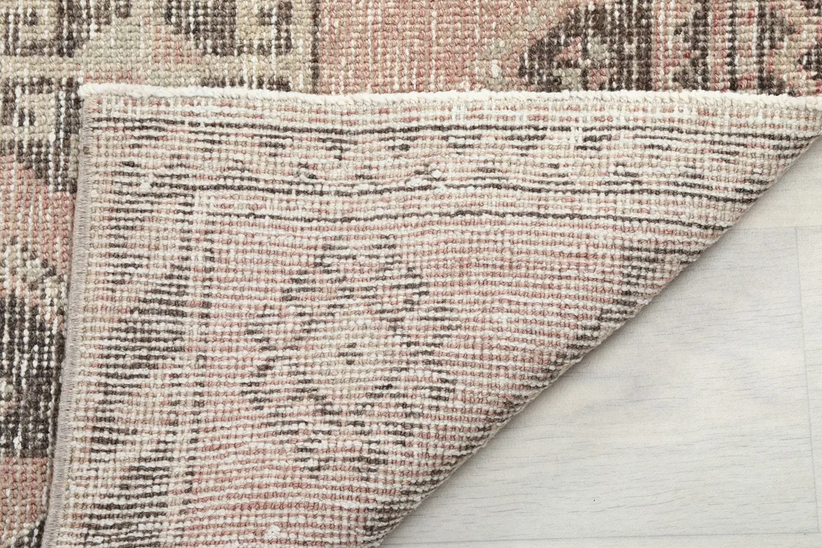 Underside of the rug, revealing the cotton foundation and fine hand-knotting work.
