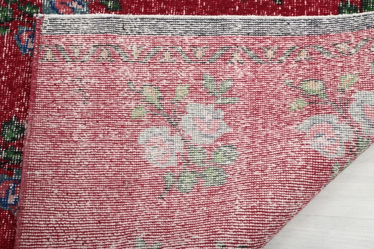 Close-up of the rug's back, showing the tight hand-knotted weave and a faint pattern.