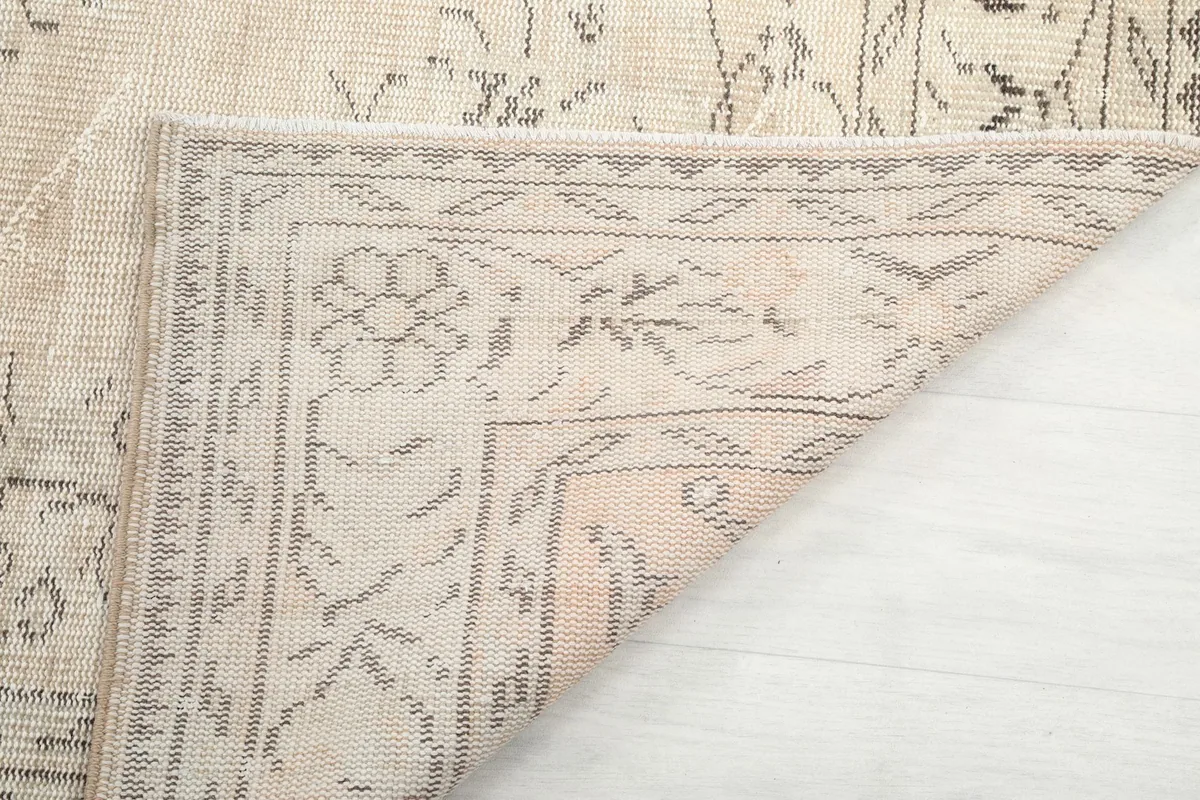 Close-up of the back of the rug, revealing hand-knotted construction