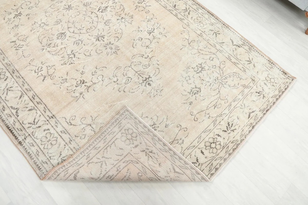 Corner of the rug folded back to show the reverse side and knotting