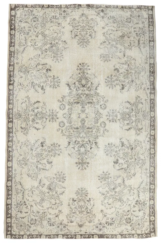 Full top view of the 6'10" x 10'5" vintage Anatolian rug with ivory field and gray floral patterns