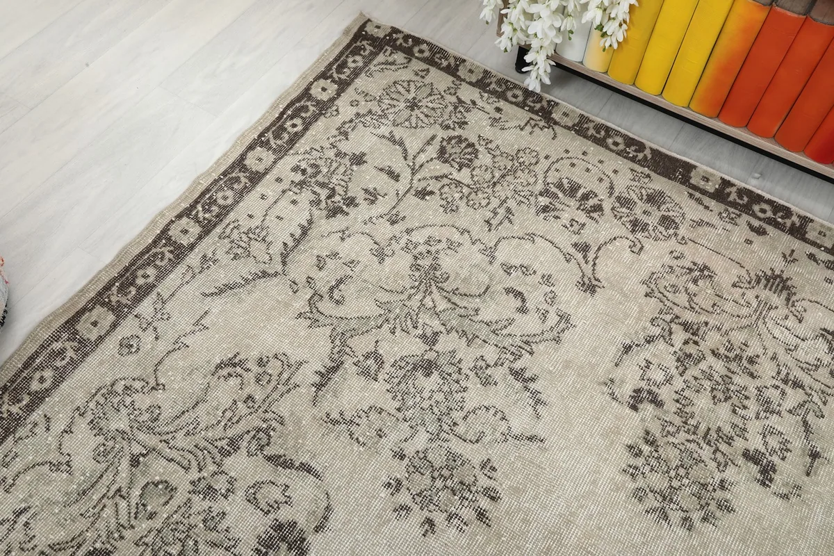 Top-down angled view of the rug, showing the consistent floral motif across the field