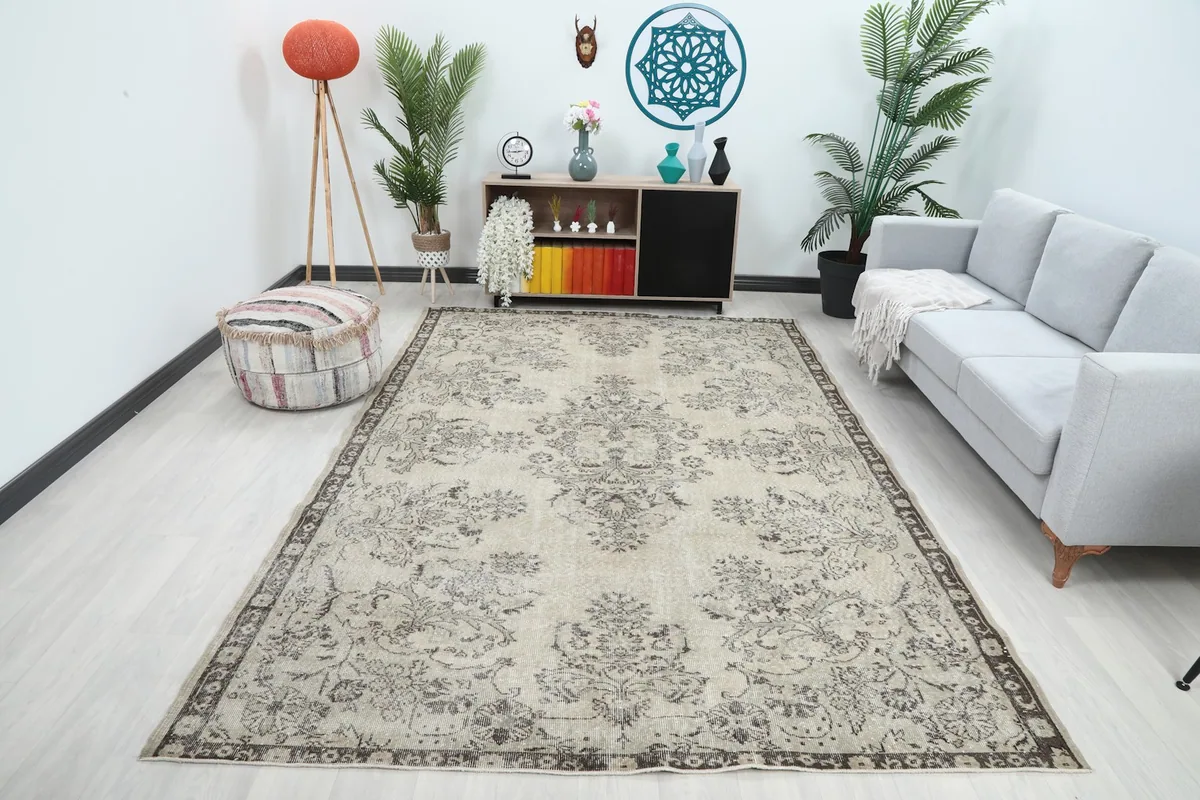 Ivory and gray floral medallion rug displayed in a bright living room setting with a sofa