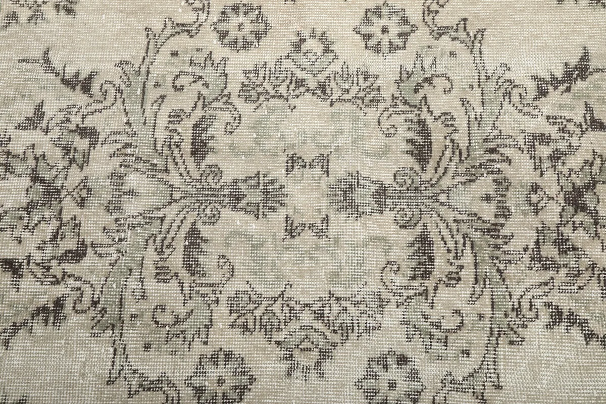 Close-up of the central medallion and intricate floral elements on the ivory background