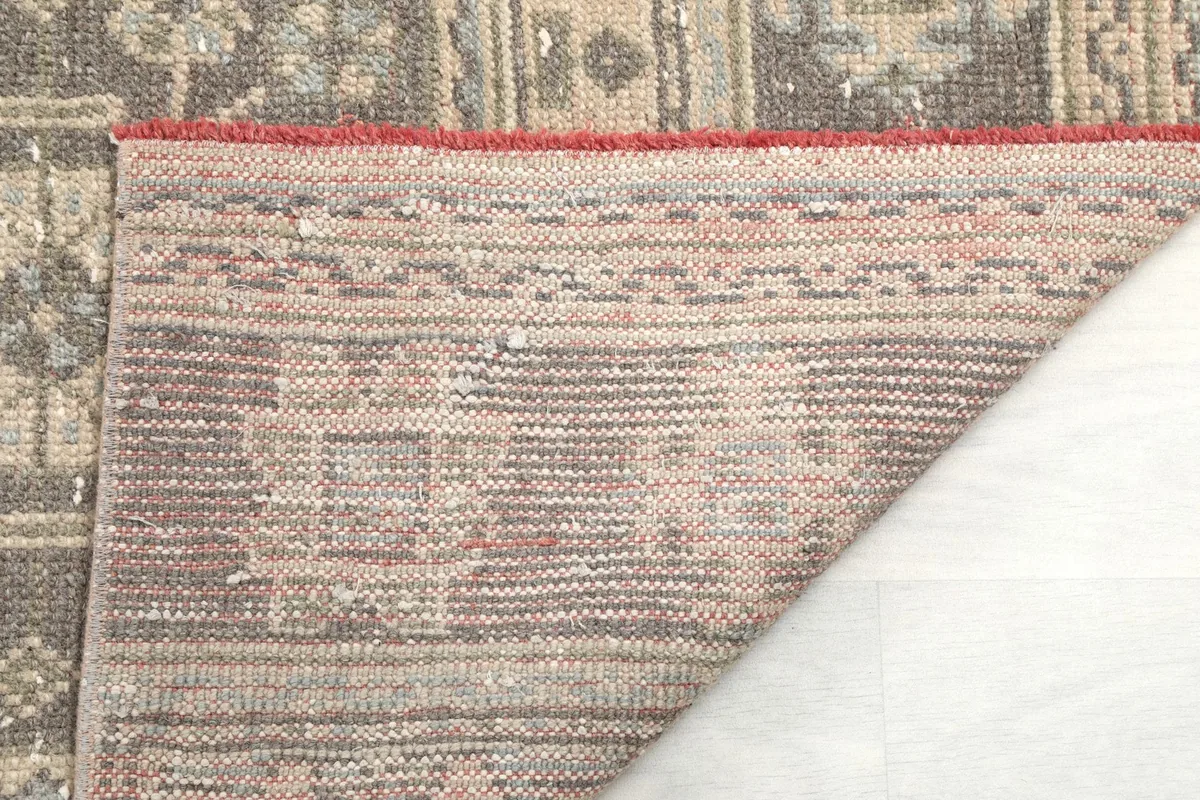 Close-up of the rug's reverse side, detailing the hand-knotted construction and foundation.