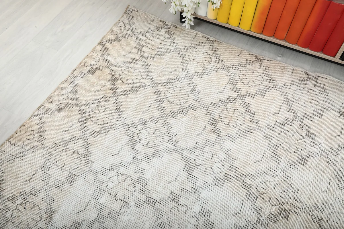 Corner view of the rug, showcasing its aged patina and color variations