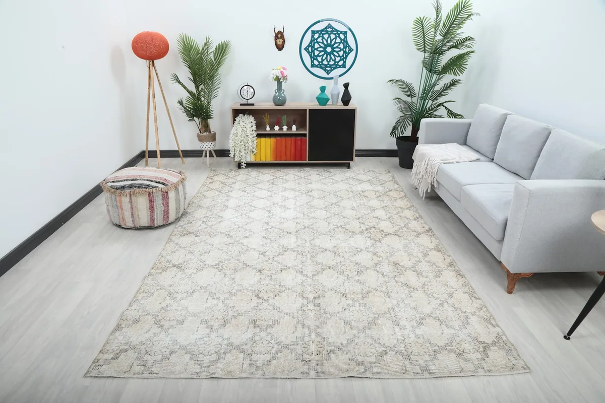 Vintage Anatolian rug in a living room setting, showing its scale next to a sofa