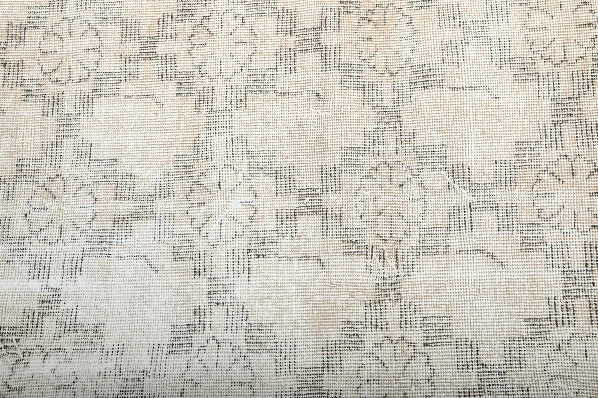 Close-up of the subtle gray geometric design against the beige field