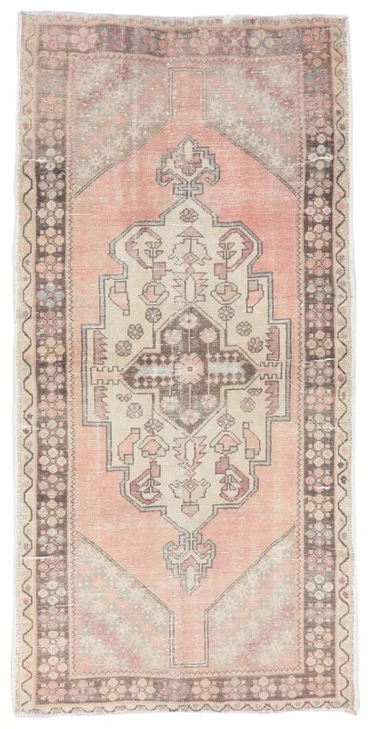 Full top view of the vintage Anatolian runner rug with a rose field and geometric medallion