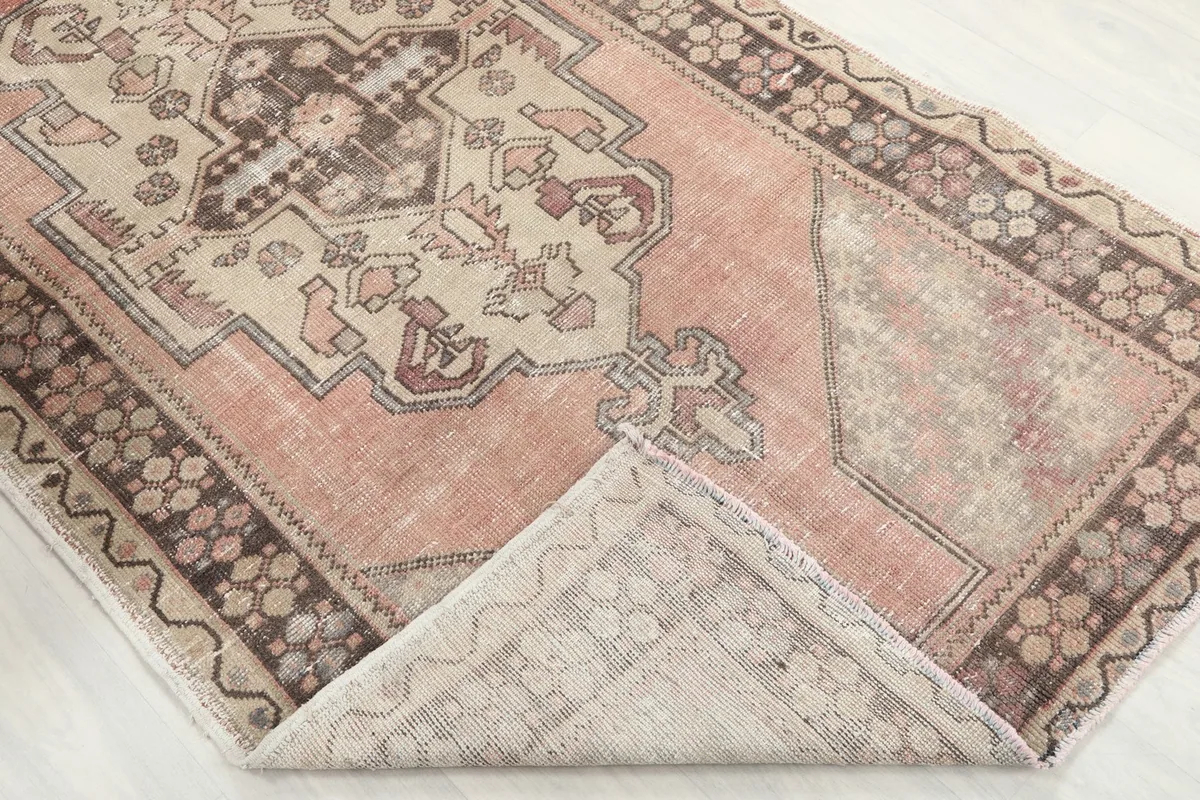 Rug corner folded back to reveal the construction and reverse side