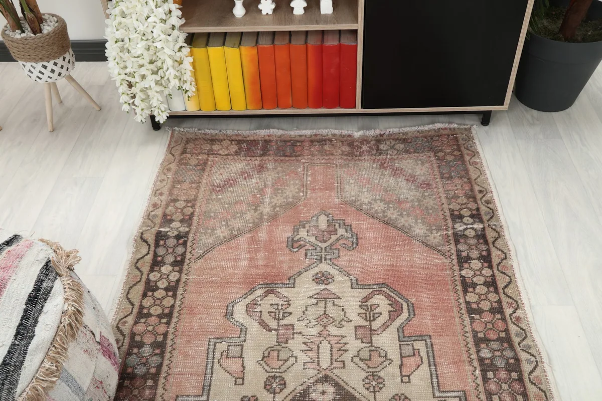 Overhead view of the rug's top half, showing the medallion and faded rose field