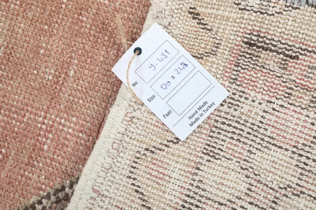 Close-up of the rug's label indicating origin and size information