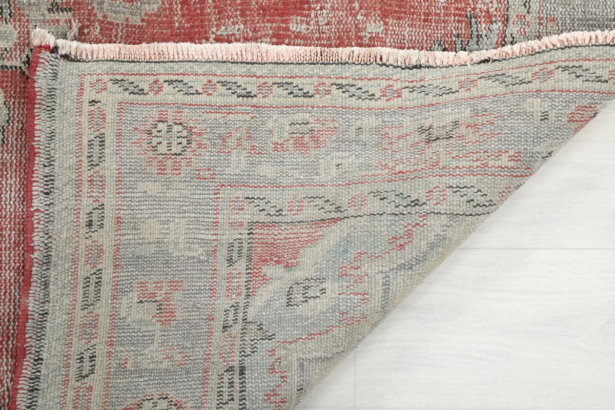 Close-up of the back of the rug, showing the hand-knotted construction and fringe.