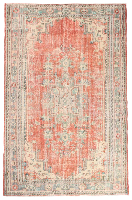 Full overhead view of the rust vintage Anatolian area rug with central medallion and geometric border