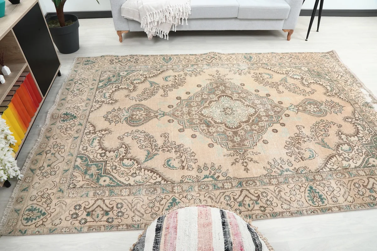 Overall view of the beige blue rug in a spacious room environment