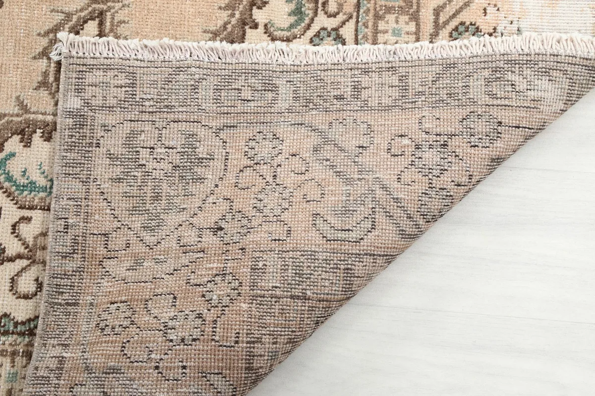Underside of the rug showing the detailed hand-knotting and foundation