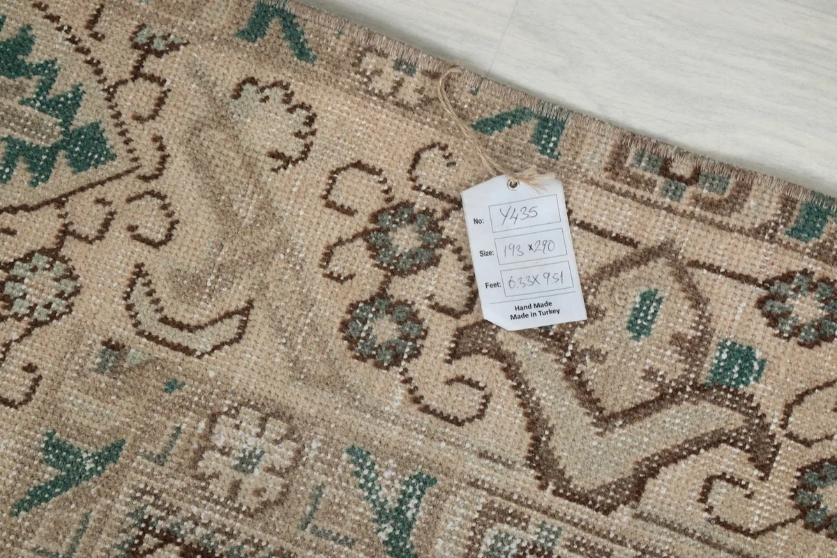 Tag displaying the rug's size and origin, lying on the rug surface