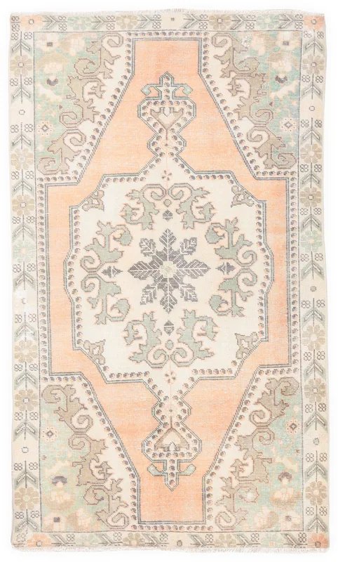 Full overhead view of the vintage Anatolian wool rug, showing its ivory, orange, green, and gray patterns