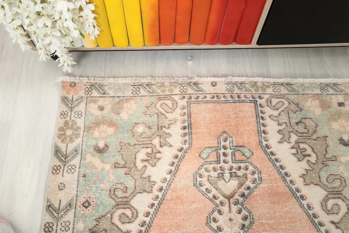 Close-up of the rug's border design featuring small floral and geometric elements