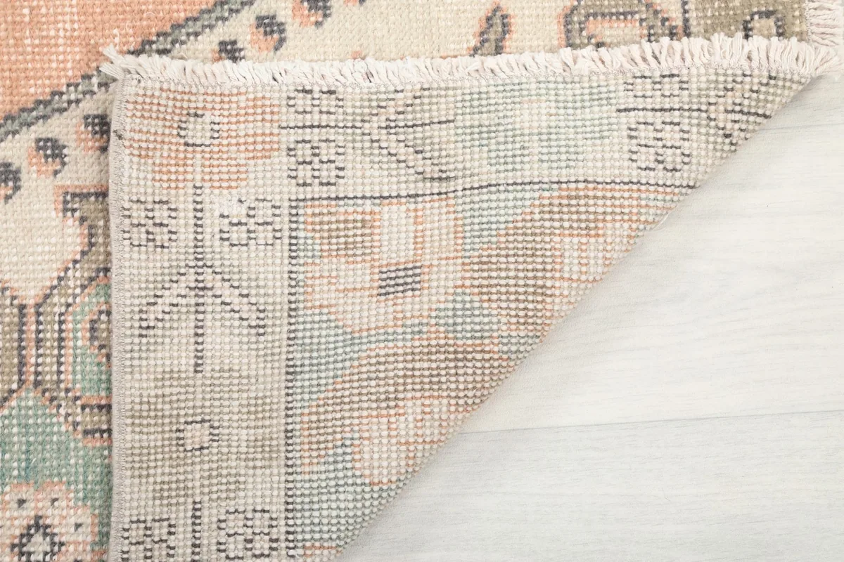 Close-up of the reverse side of the rug, showing the knotting structure and foundation
