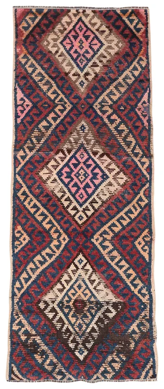 Full overhead view of the navy and rust geometric vintage runner rug on a white background.