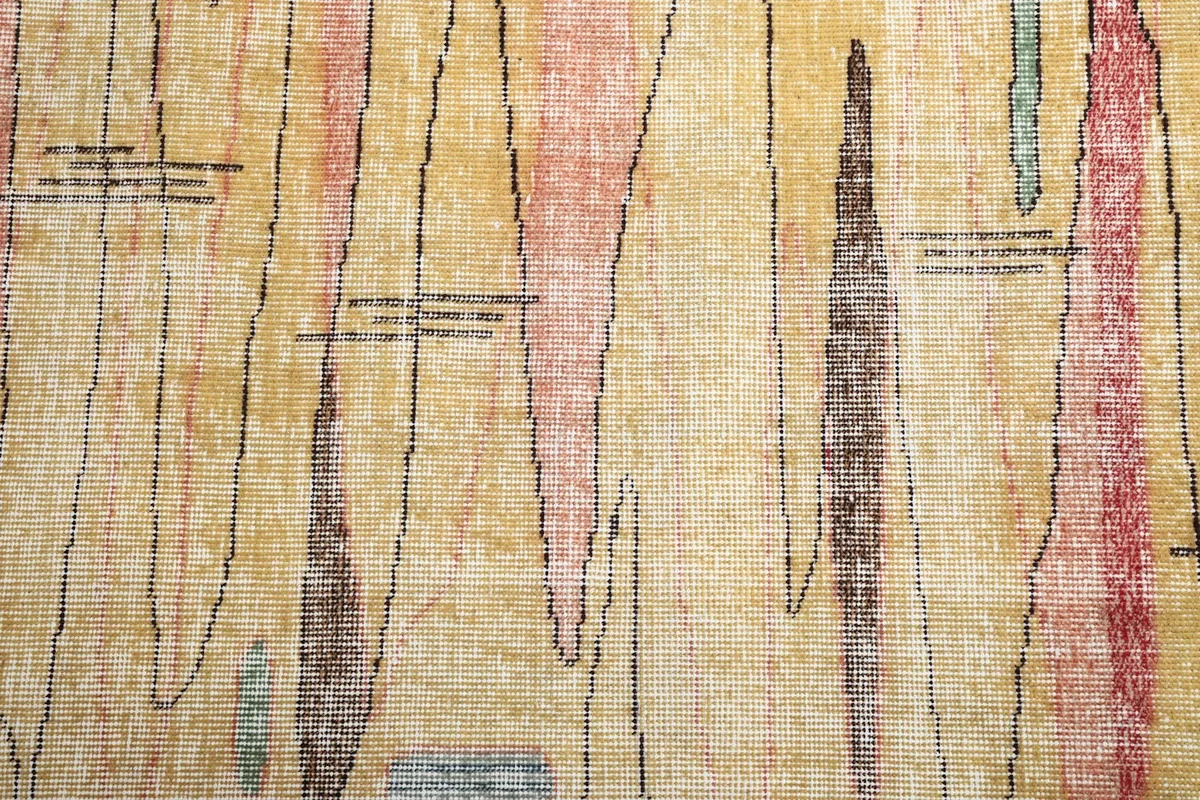 Close-up of the distressed wool pile and intricate abstract lines in various colors